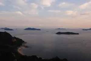 Islands of the Seto Inland Sea silhouetted at dusk, seen from a hillside