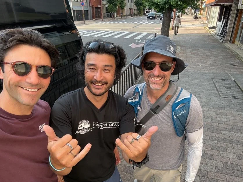 Three smiling companions at the end of the Saba Kaido walk